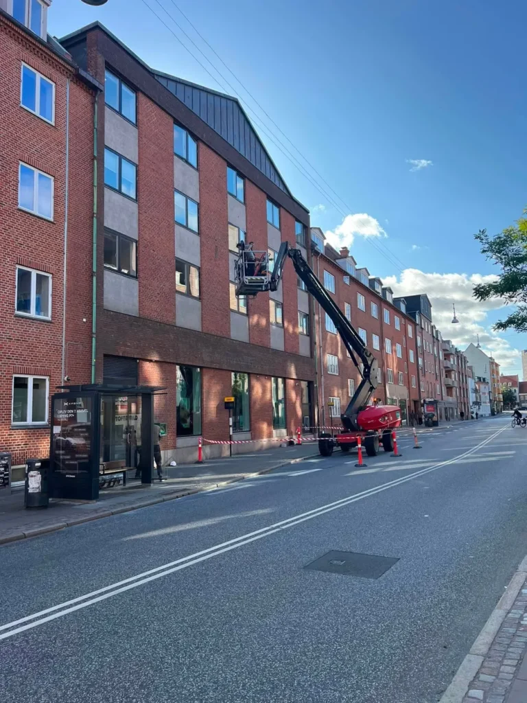 Bomlift med kurv i fjerde sals højde ved facaden i Vingårdsgade i Aalborg